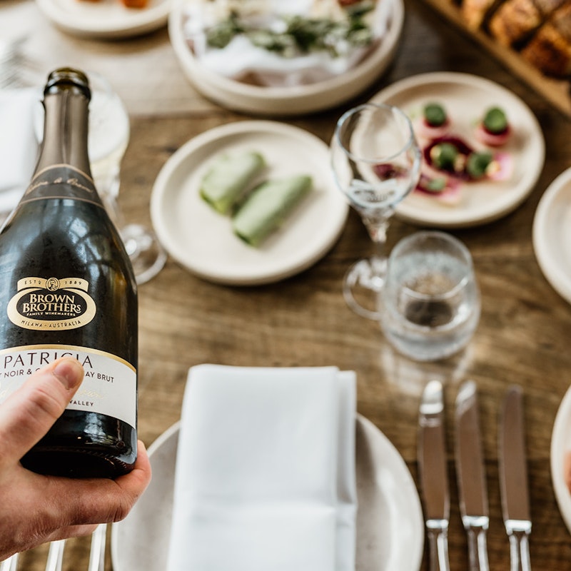 Bottle of Patricia sparkling being poured at a table in the Brown Brothers Restaurant