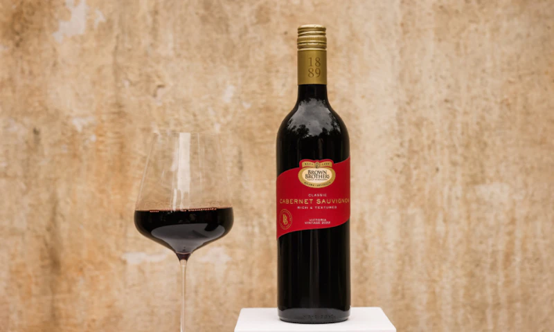 A bottle of Brown Brothers Cabernet Sauvignon with a glass of wine