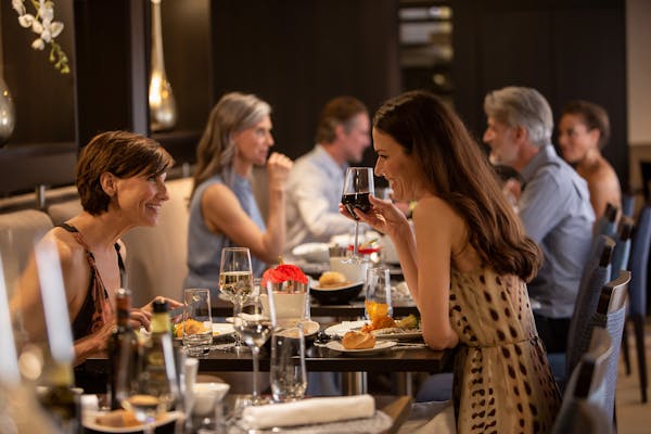 Friends enjoying dinner on cruise