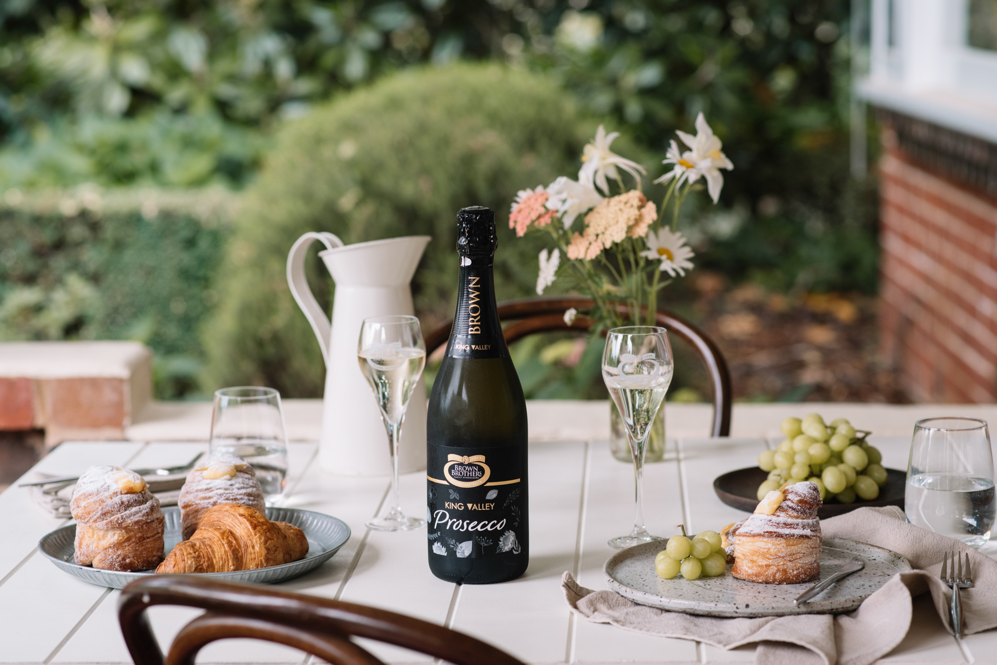 prosecco NV on an outdoor table set with pastries and green grapes