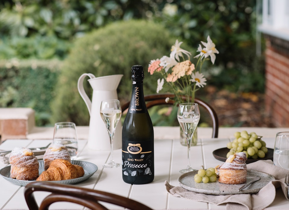 prosecco NV on an outdoor table set with pastries and green grapes