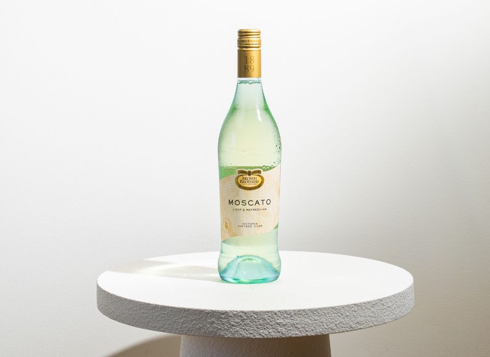 A bottle of Browwn Brothers Moscato on a table