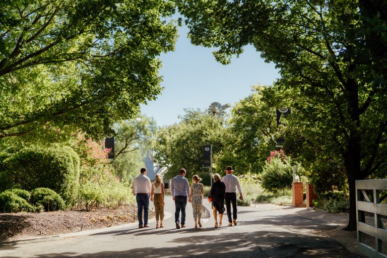 Group of friends walking into entrance of Brown Brothers Winery