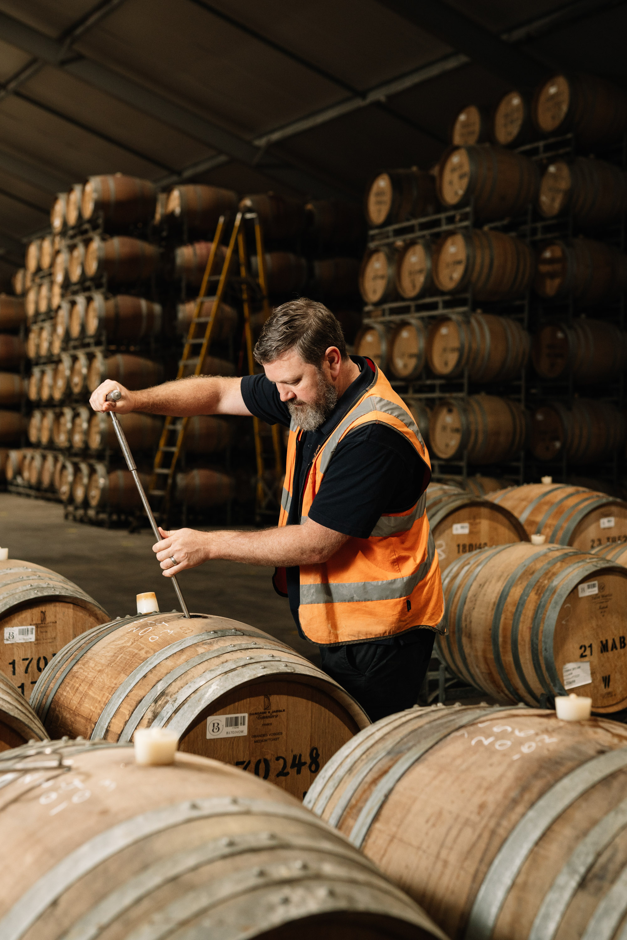 Winemaker Simon McMillan taking a barrel sample