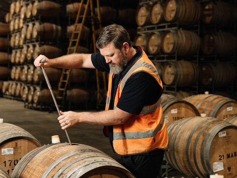 Winemaker Simon McMillan taking a barrel sample