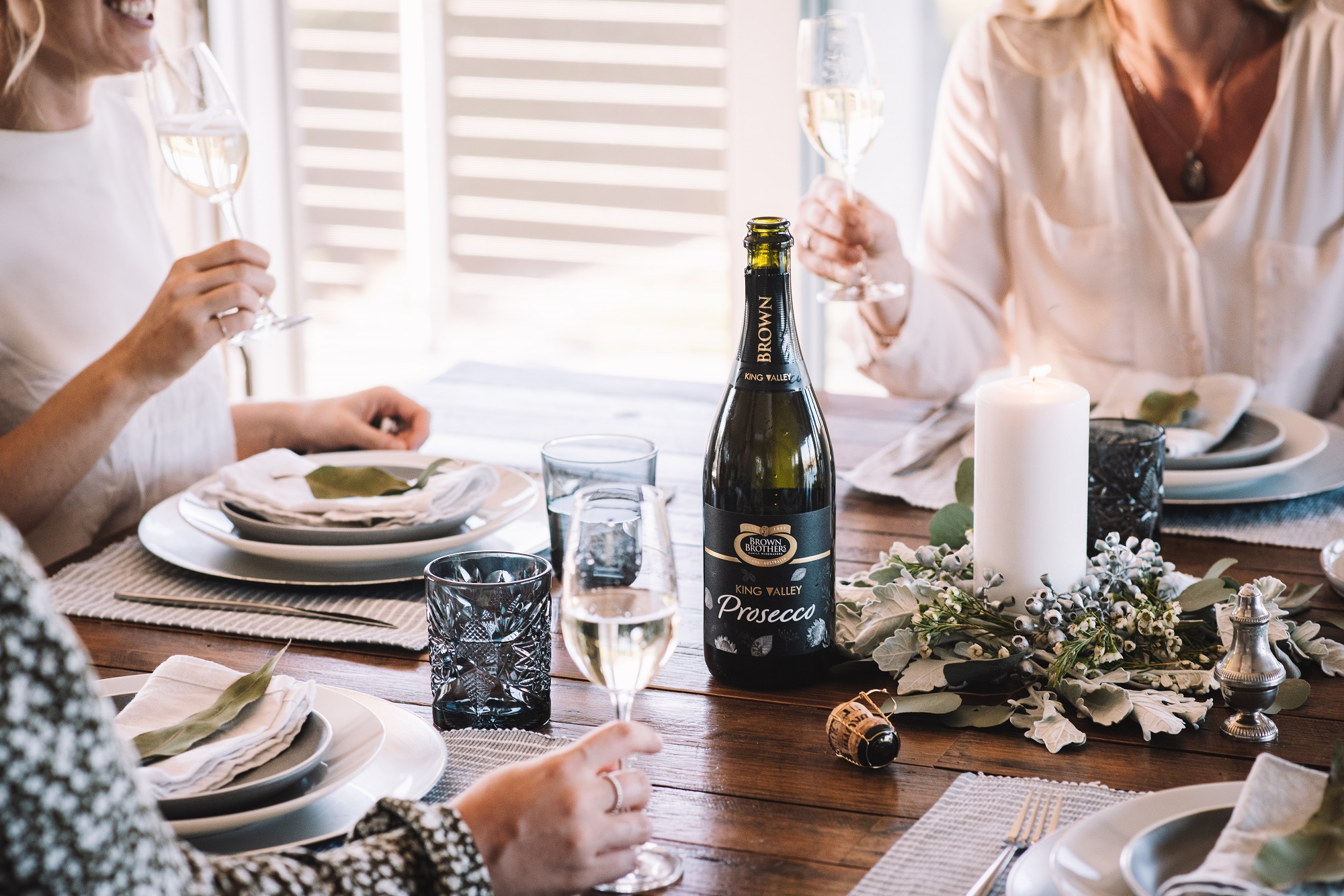 festive table setting with bottle of brown brothers prosecco 