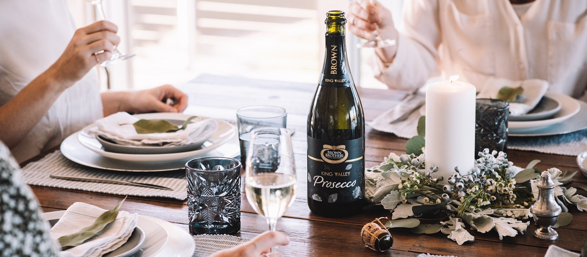 festive table setting with bottle of brown brothers prosecco 