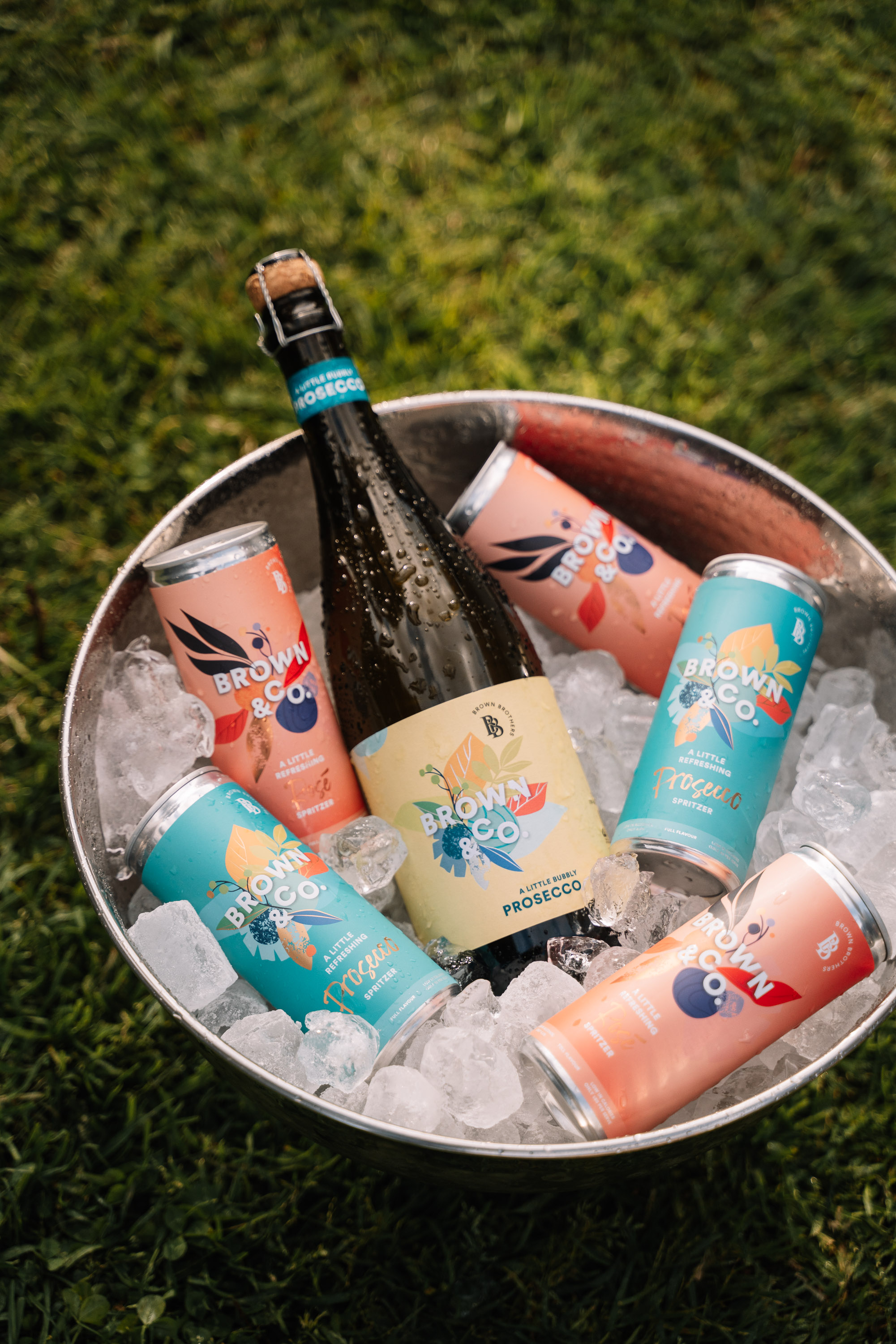 Brown & Co. Prosecco and cans in an ice bucket