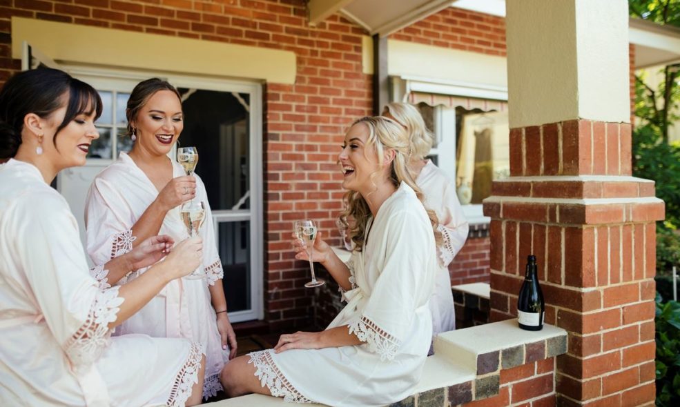 Bridal party enjoying glass of sparkling pre-wedding