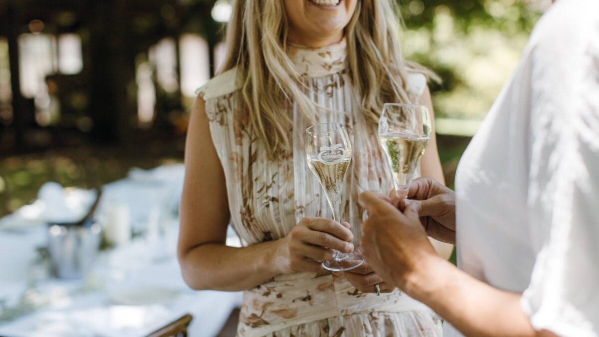 Woman holding Brown Brothers sparkling in hand