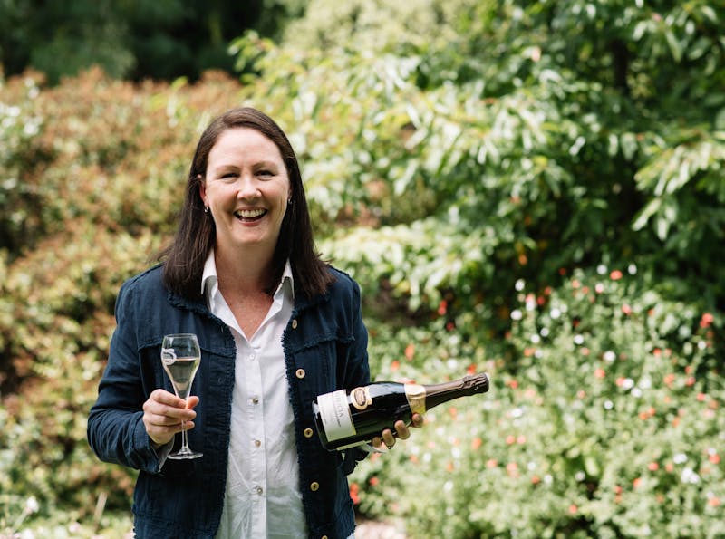 Winemaker Cate Looney holding a bottle of Patricia Extended Lees