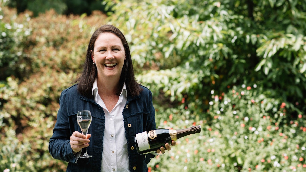 Winemaker Cate Looney holding a bottle of Patricia Extended Lees