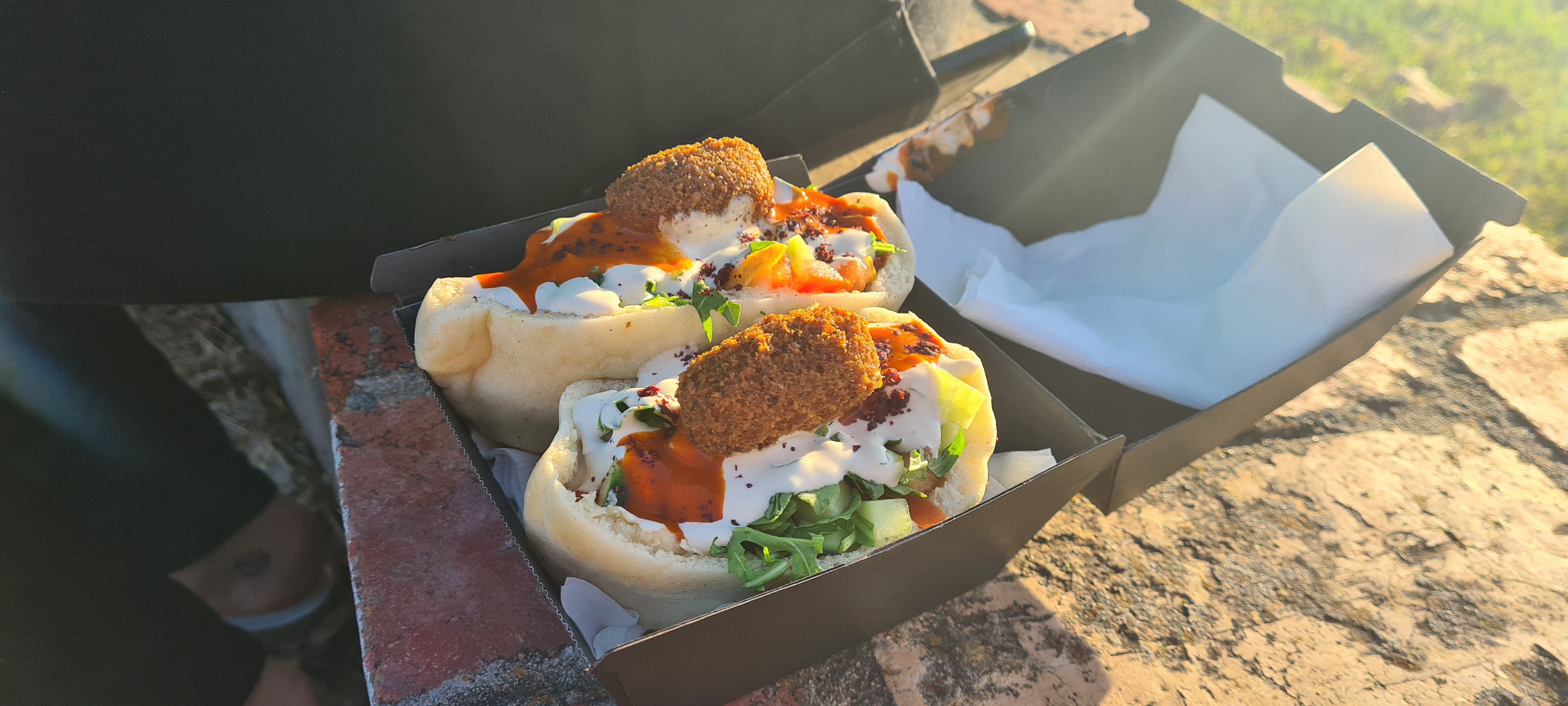 Pita bread stuffed with roast cauliflower, salad and falafel