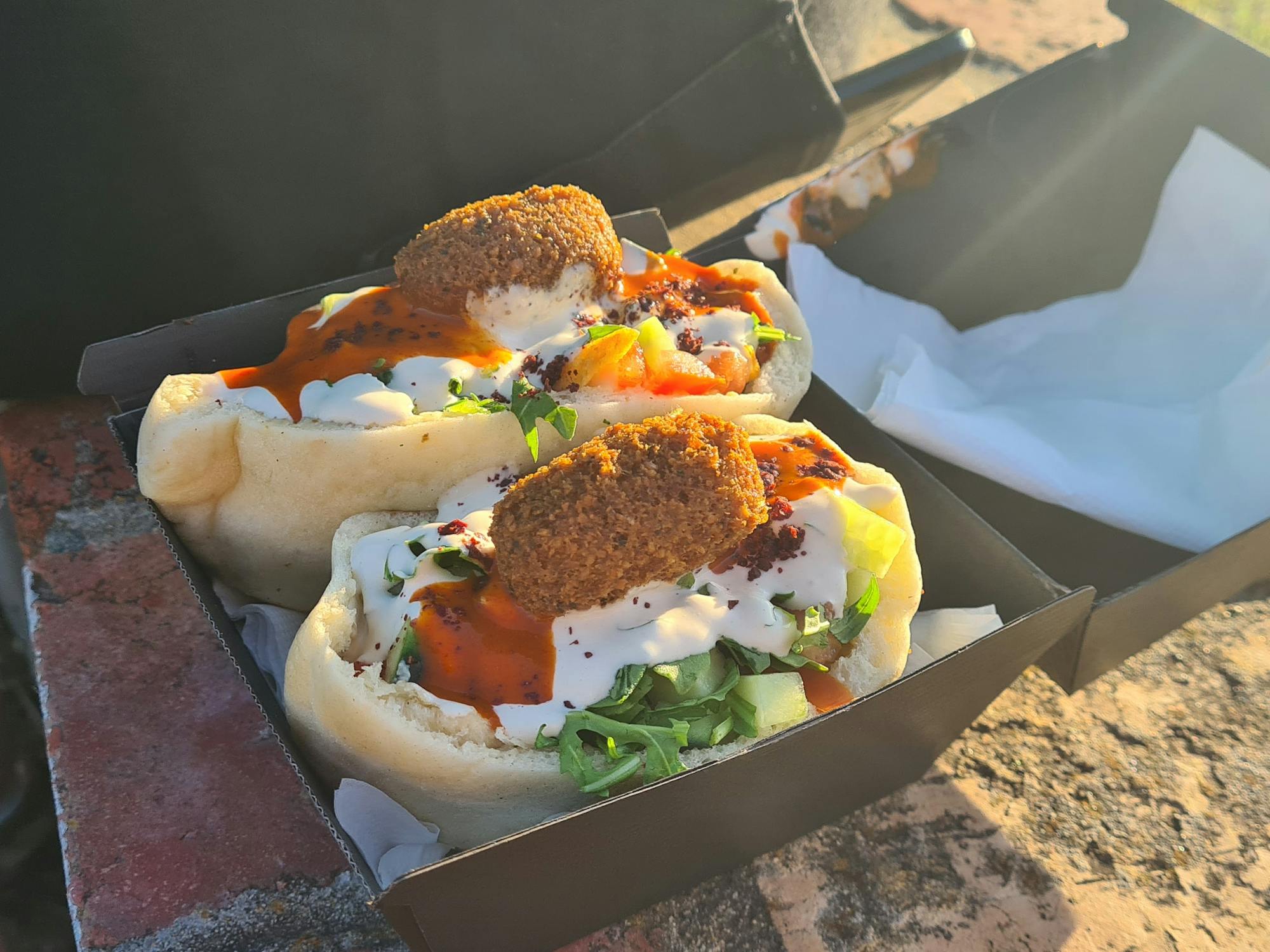 Pita bread stuffed with roast cauliflower, salad and falafel