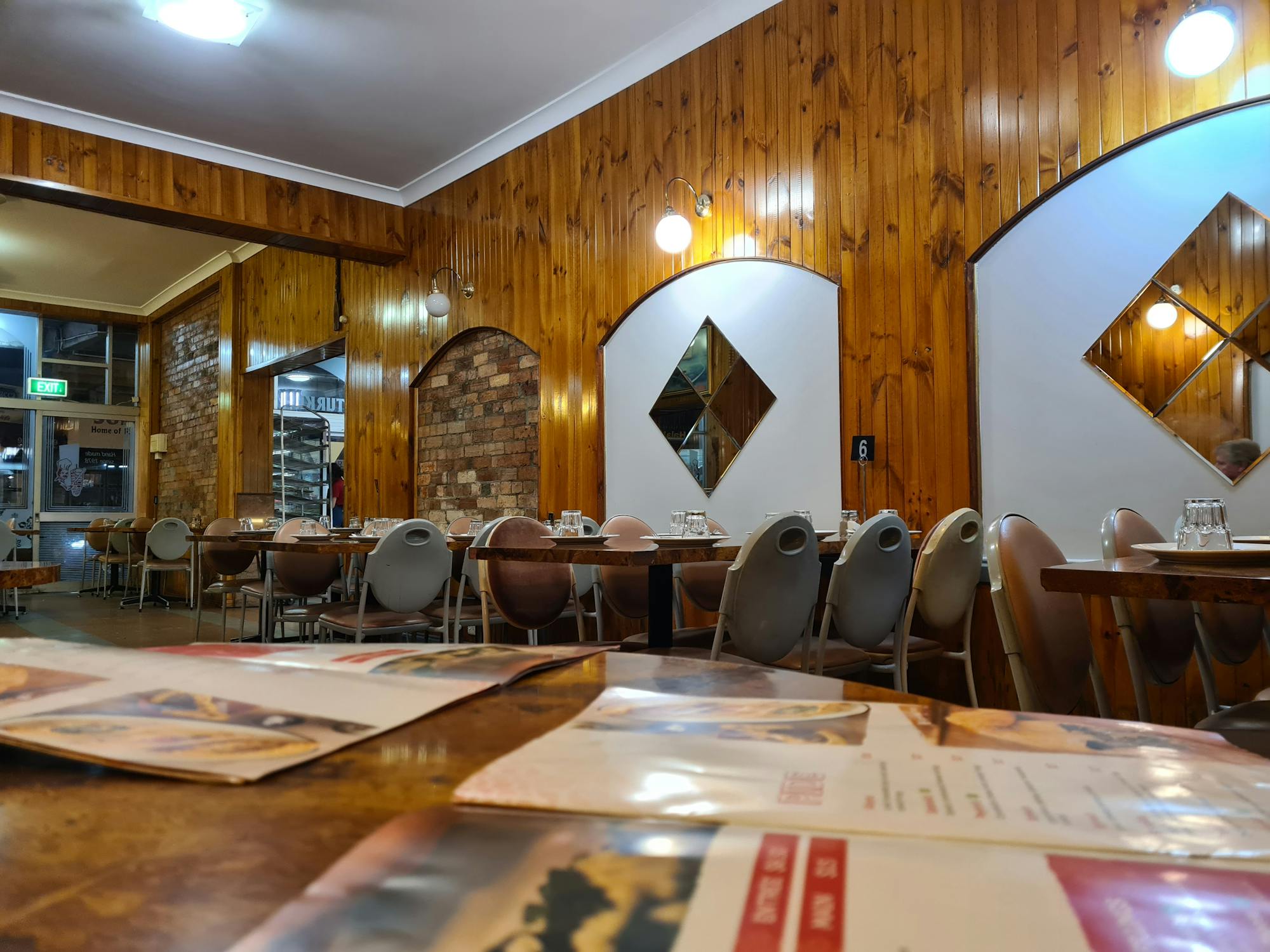 Inside of Alasya with wooden panelling, mirrors, and old-school seating.
