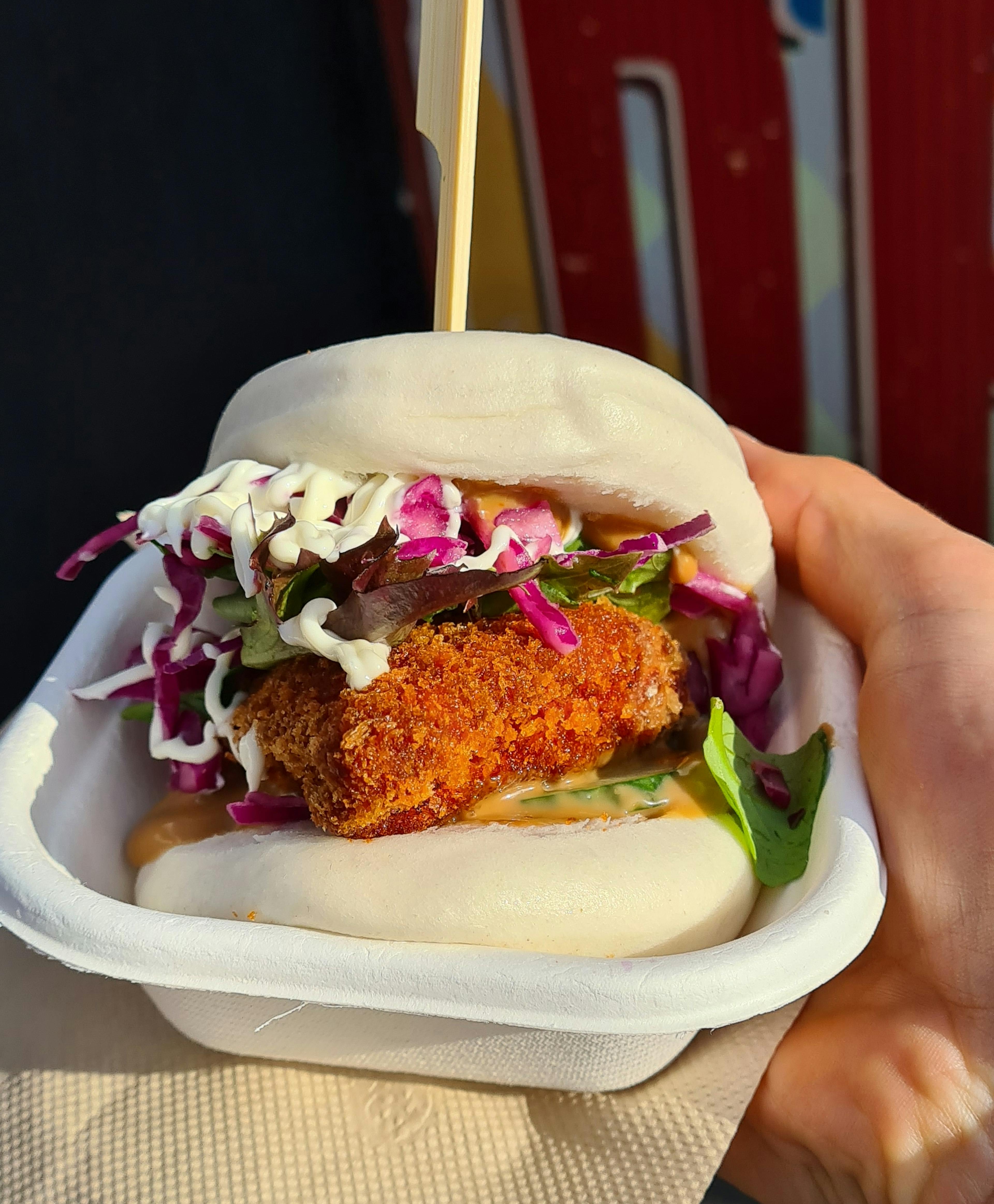 Deep fried chicken on a bao bun with cabbage slaw and mayonnaise