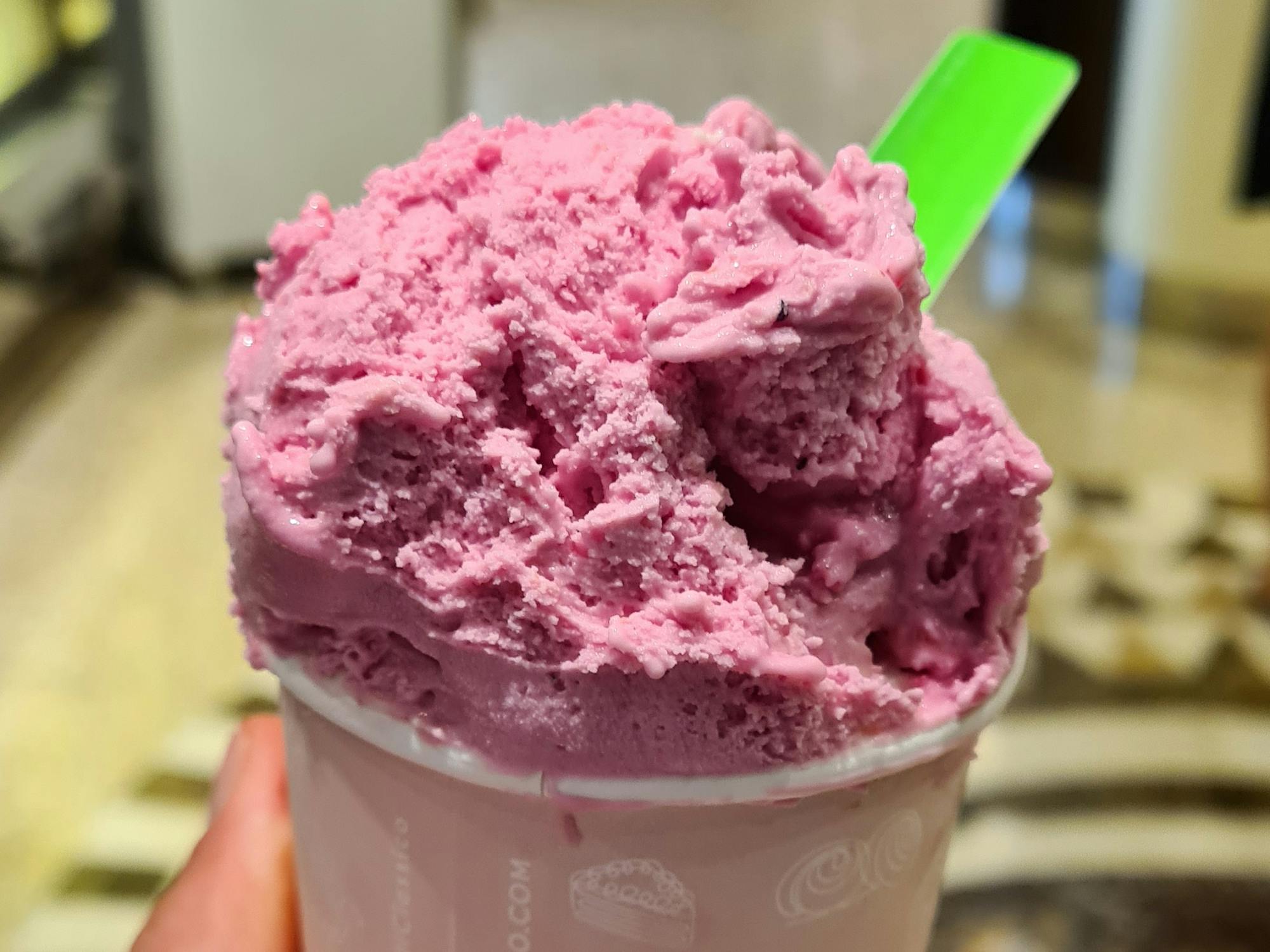 Vibrant deep pink ice cream in a cup