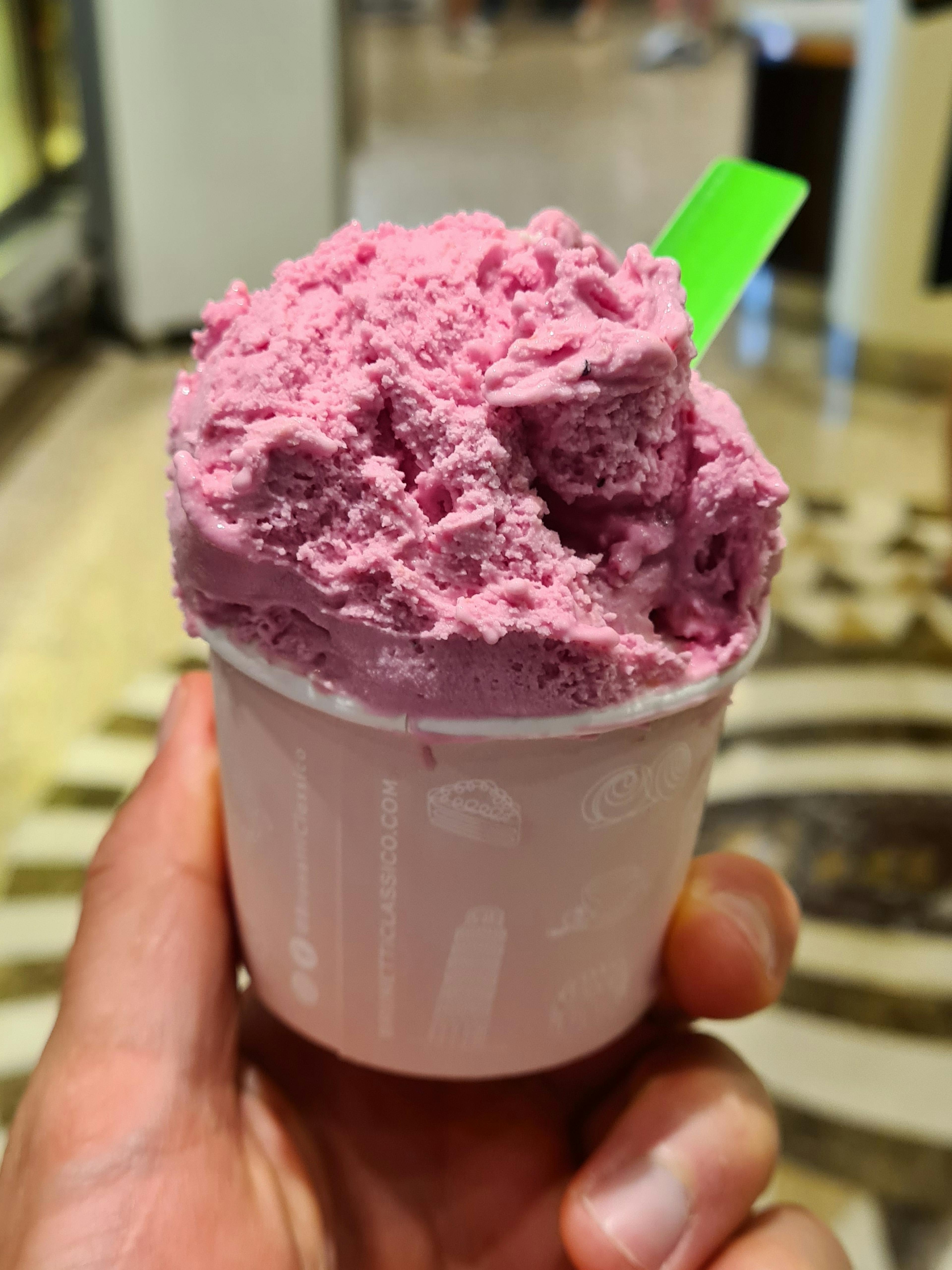 Vibrant deep pink ice cream in a cup