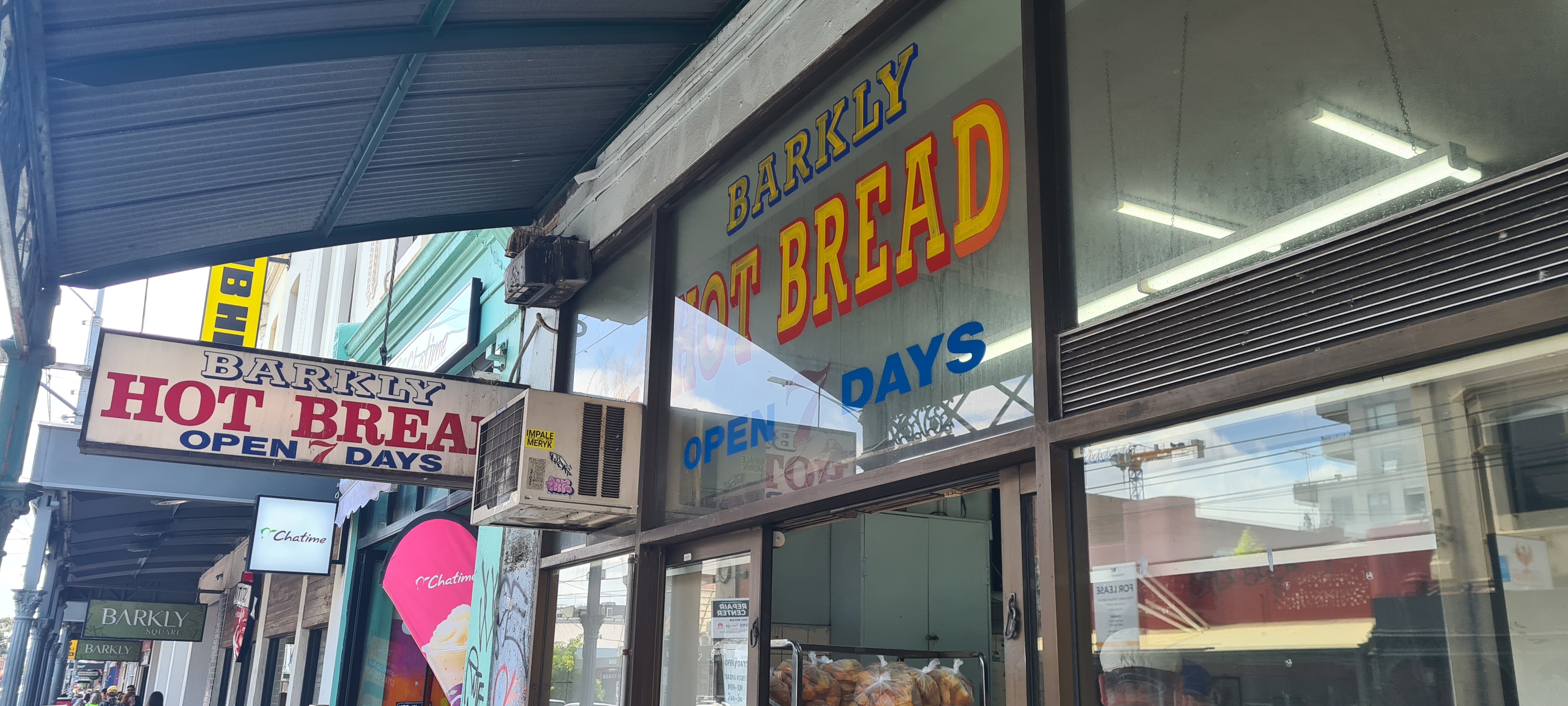 Bakery shop front showing a sign denoting 'open 7 days'