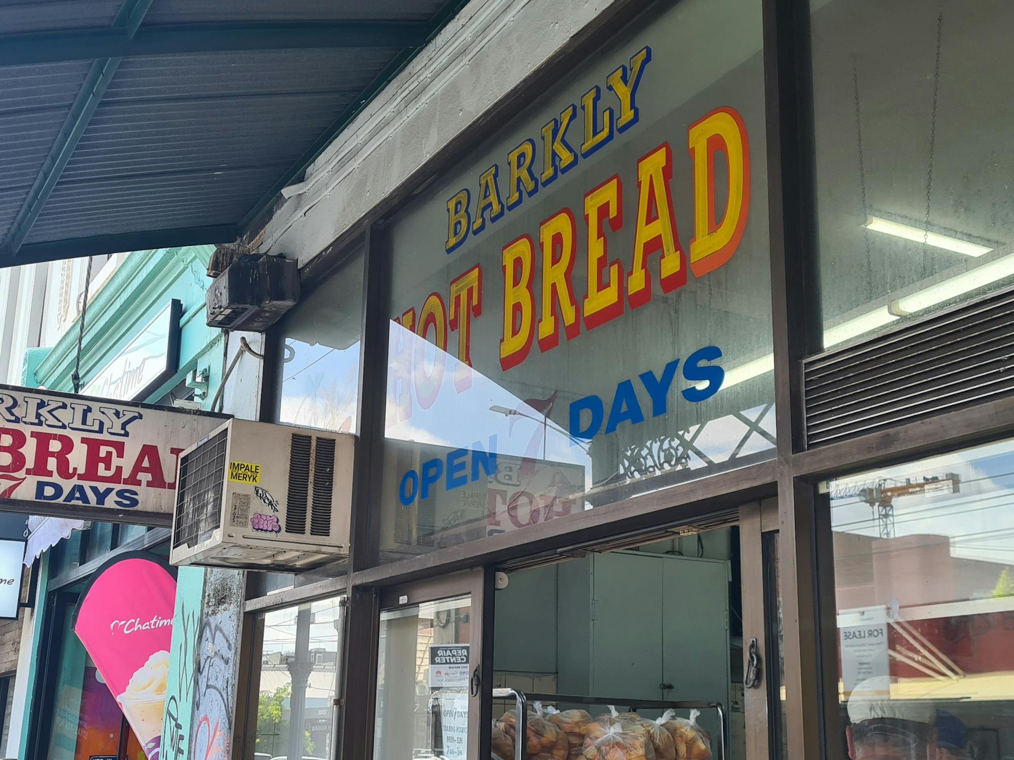 Bakery shop front showing a sign denoting 'open 7 days'