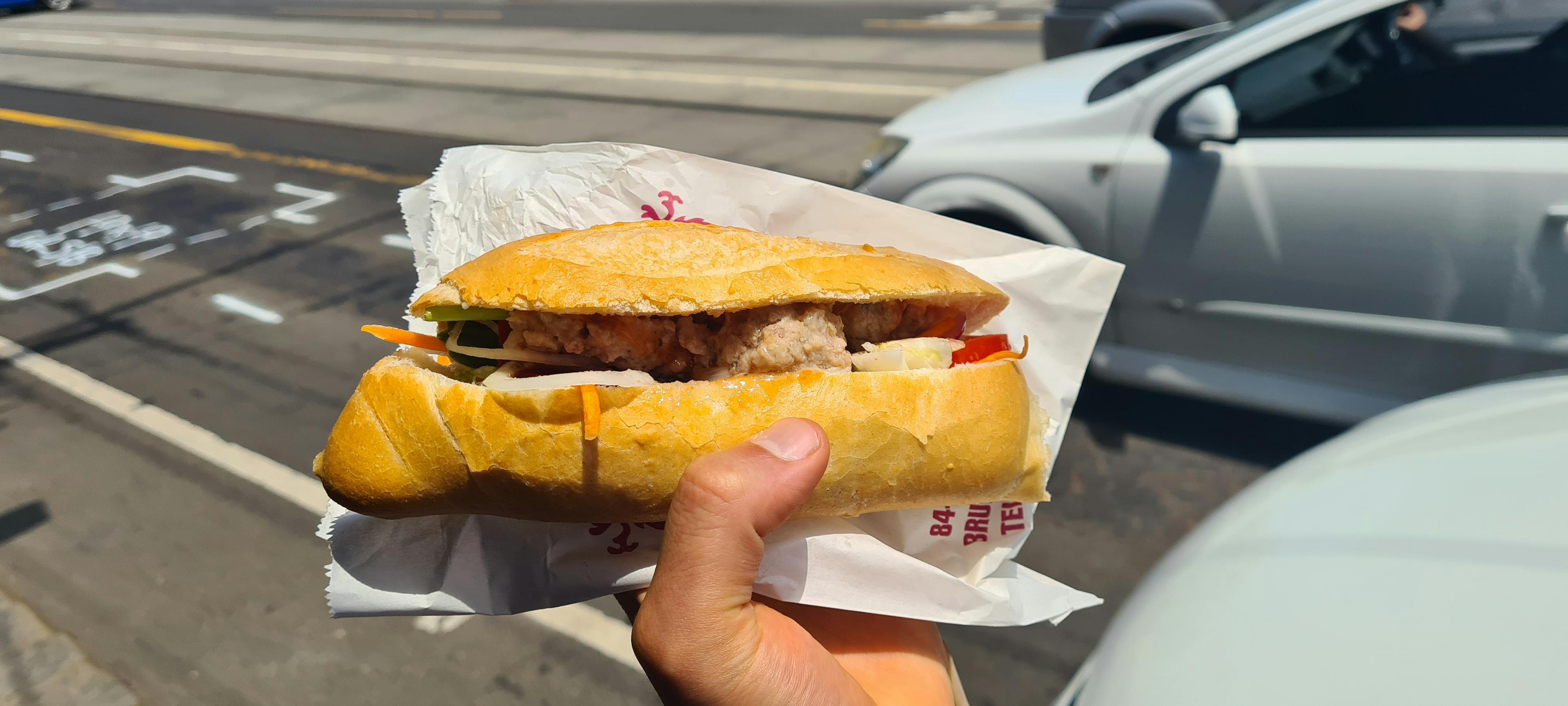 Salad roll with meatballs, carrot, tomato and lettuce.