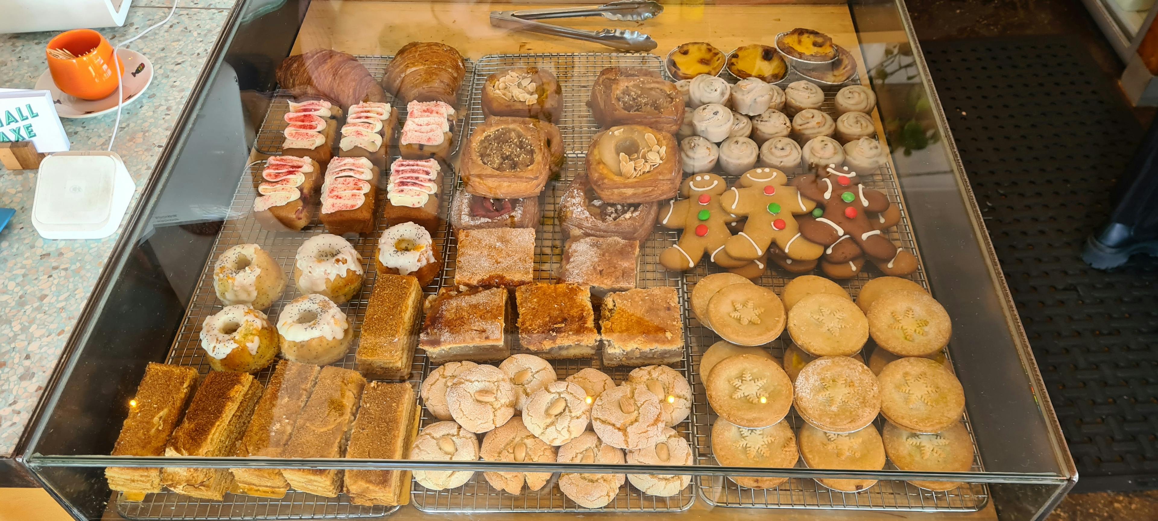 Pastry cabinet with cakes, croissants, danishes and left over Christmas fare. 