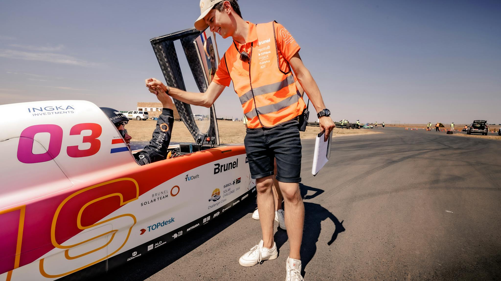 Race manager gives driver a high five to the driver in Nuna