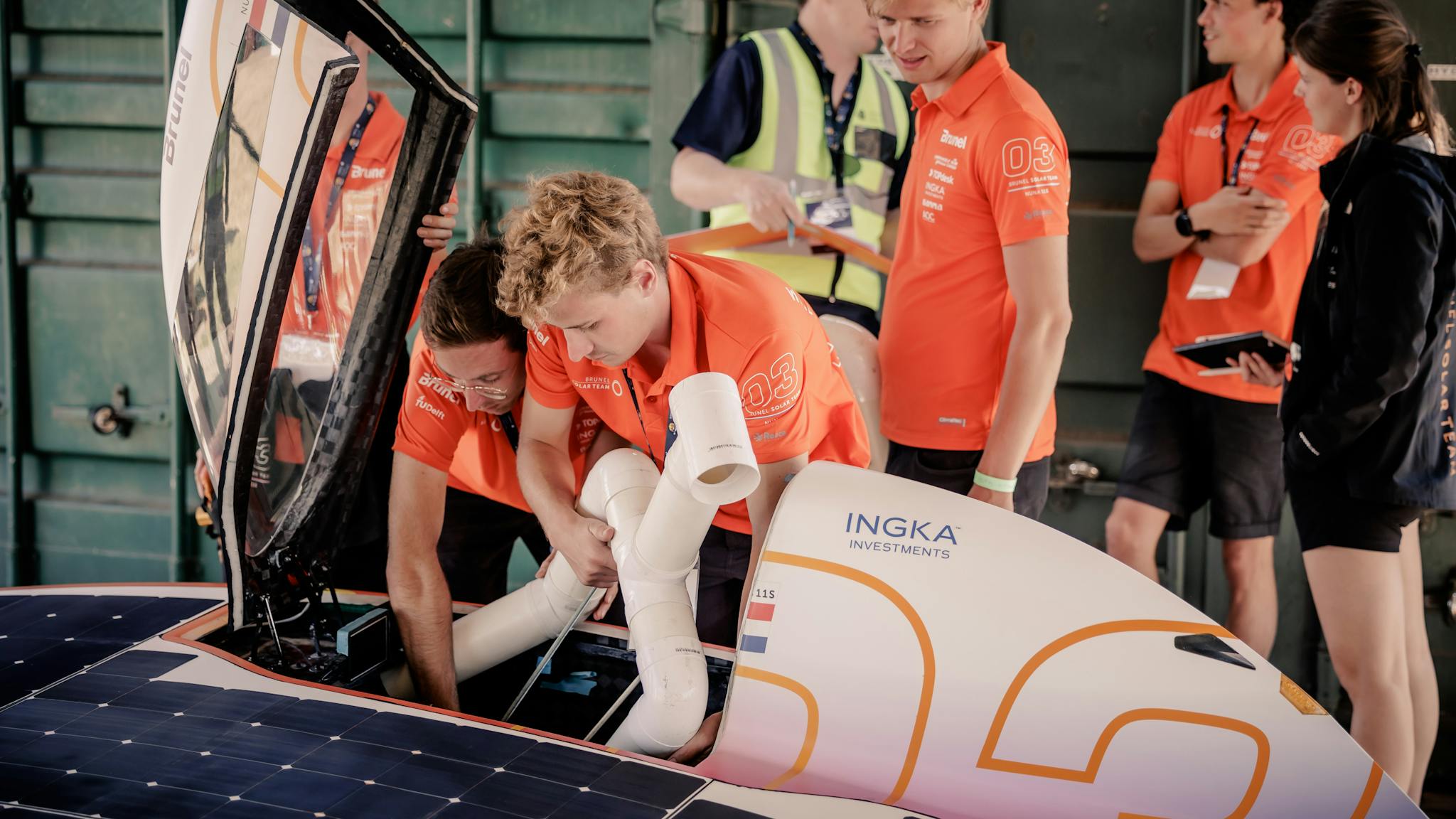 the team placing a PVC dummy in Nuna during Static Scrutineering