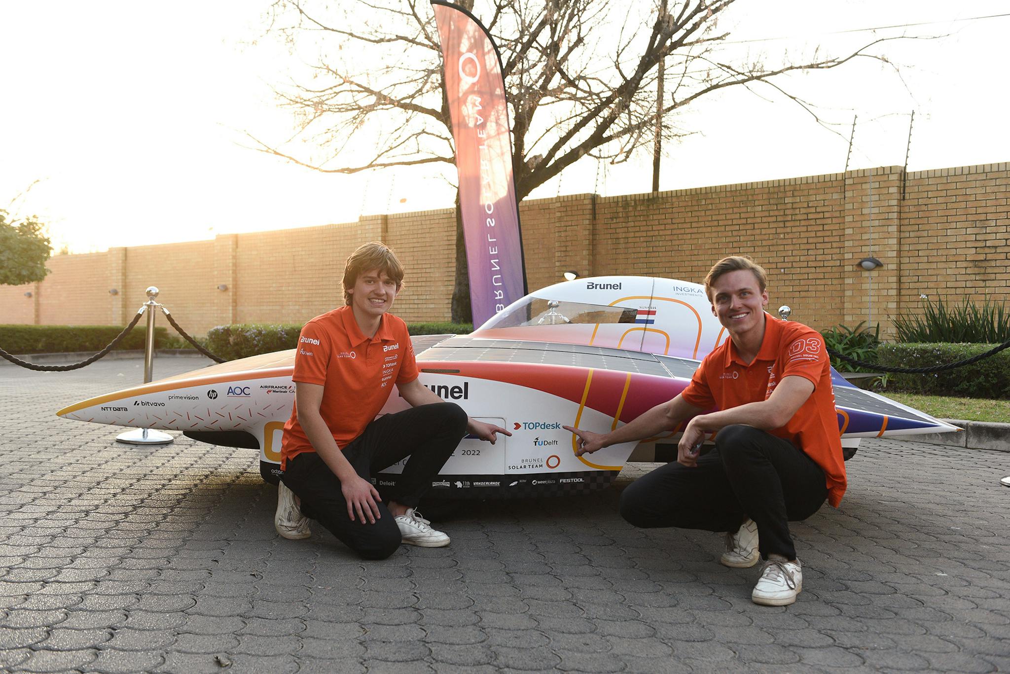 Lucas and Xavier with the Topdesk logo on Nuna 11s