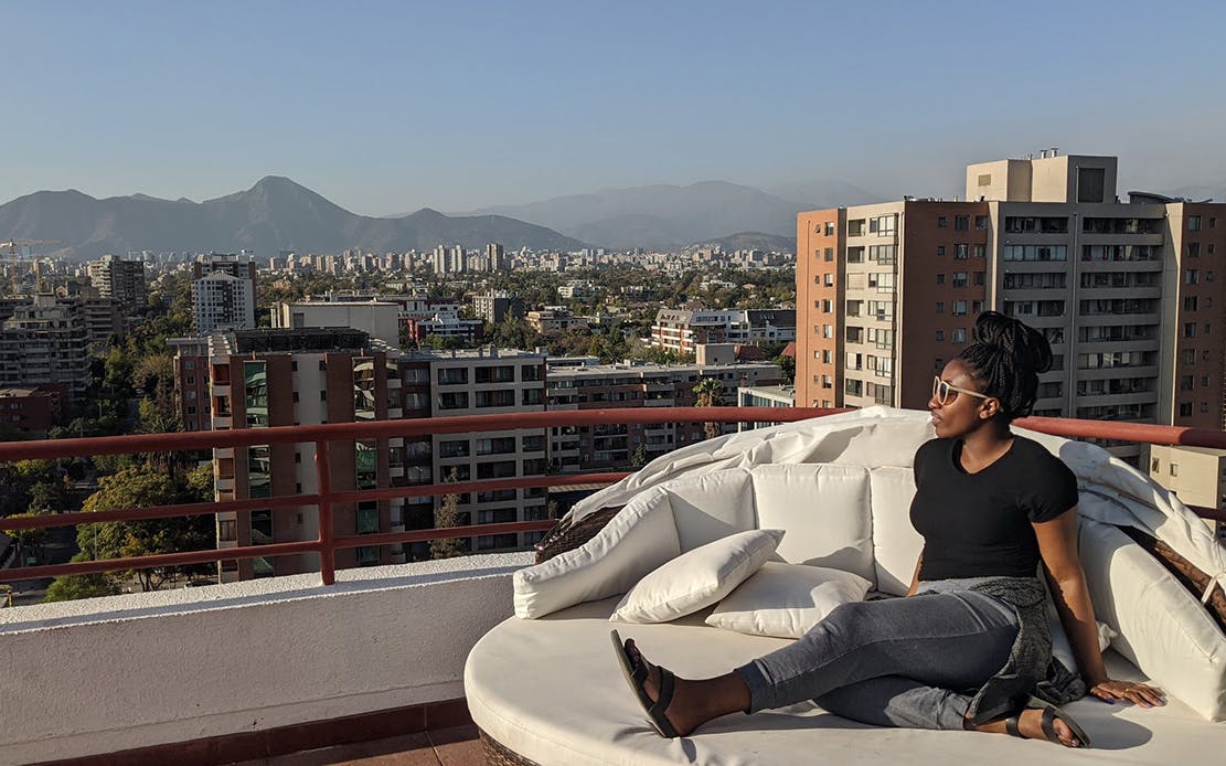 Partial view of Santiago Chile from a rooftop and me looking at the sun