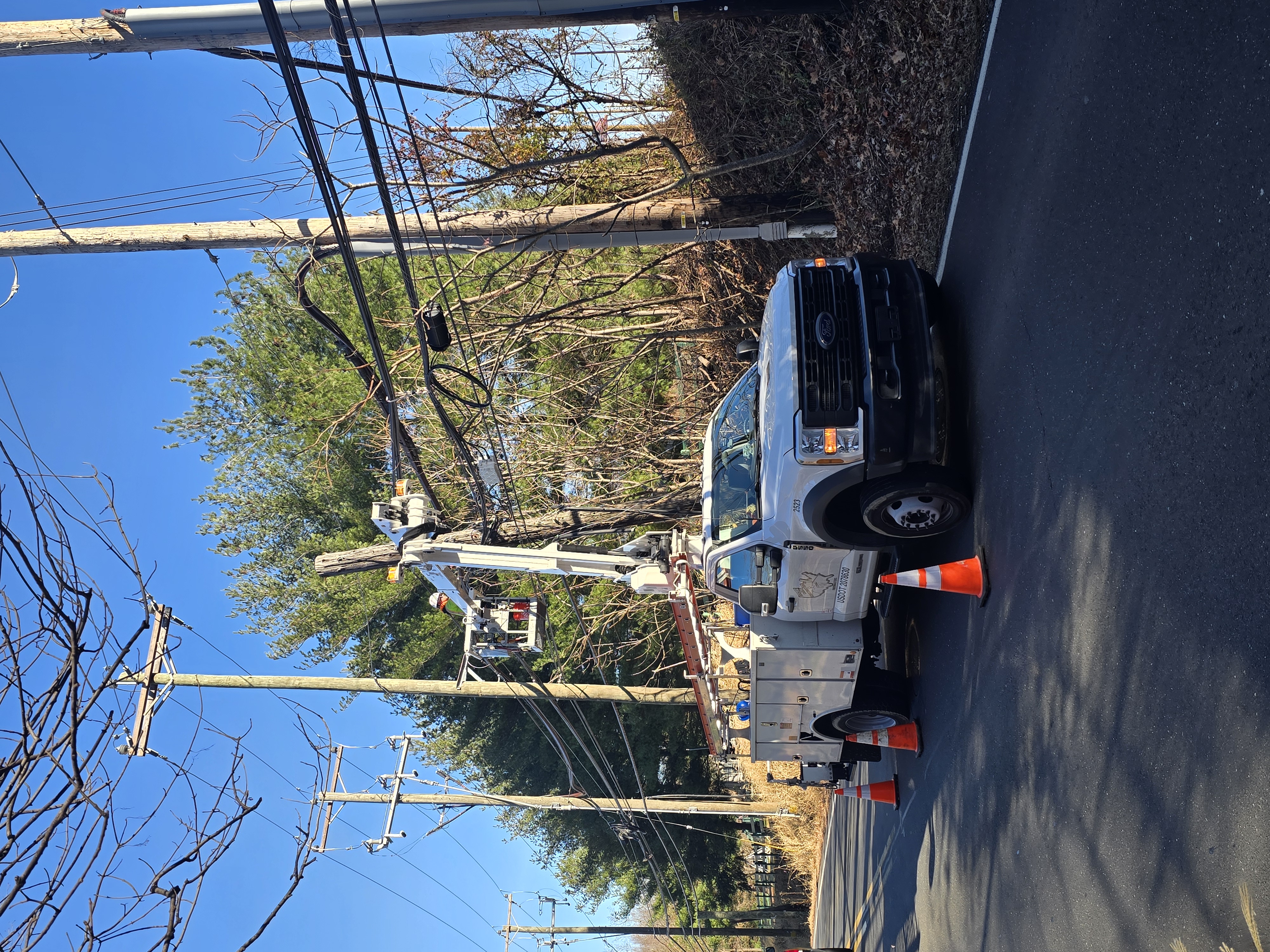 Aerial crew performing a complex pole transfer as part of routine maintenance work.