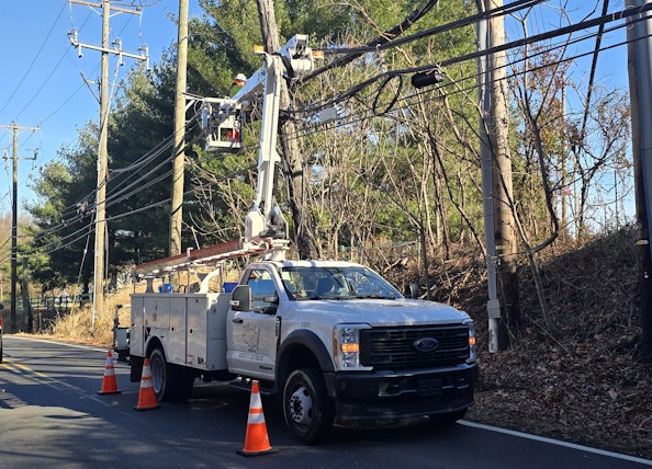 Aerial crew performing a complex pole transfer as part of routine maintenance work.