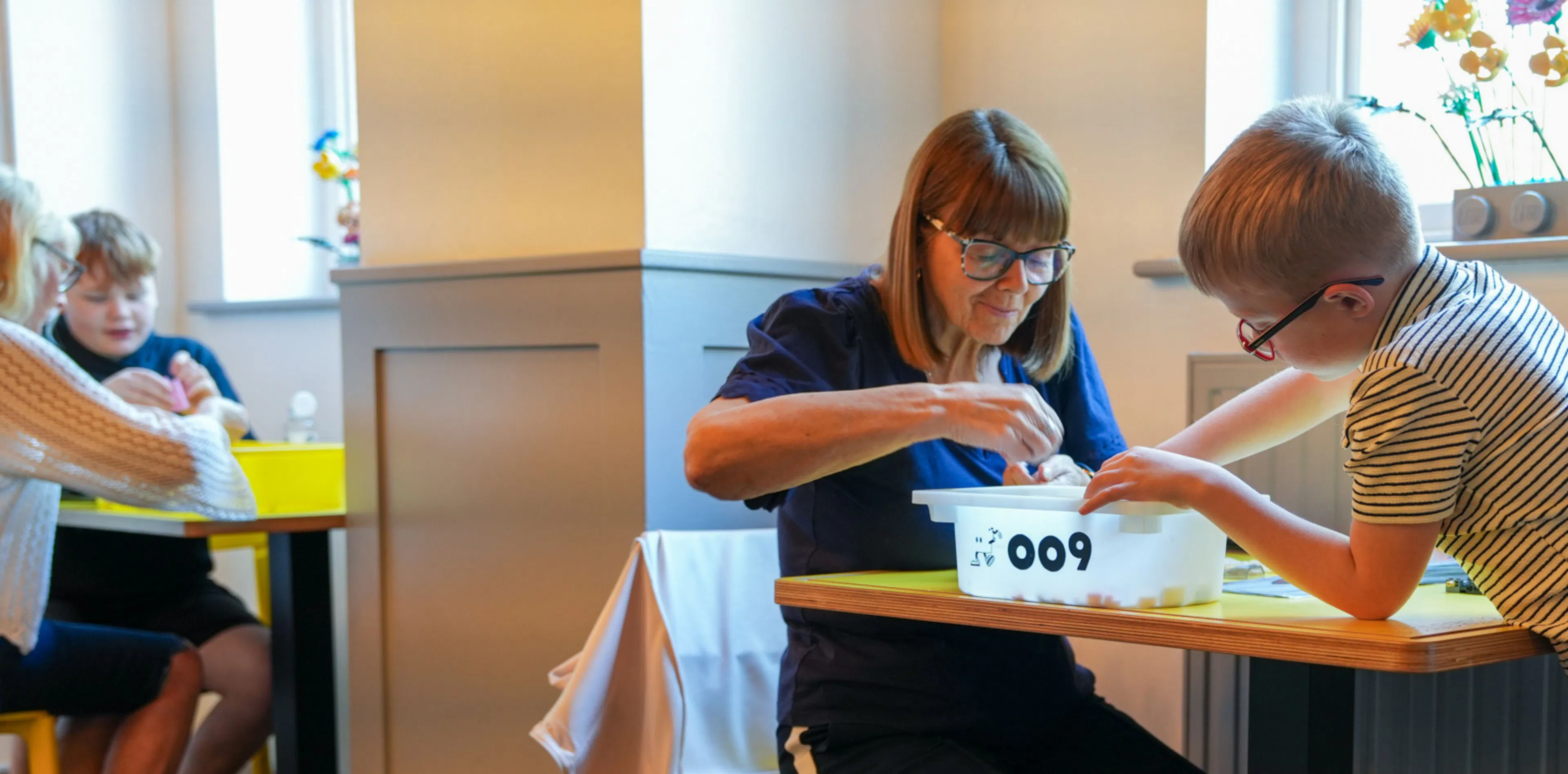 Customers building LEGO in the cafe.