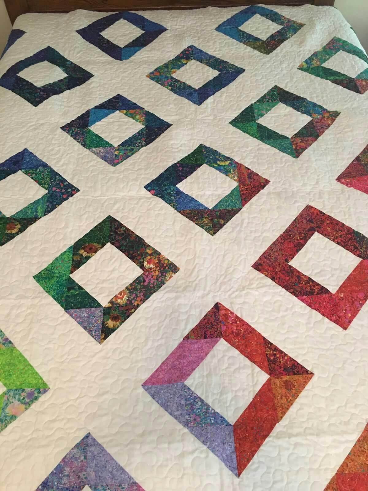 Multicolor squares on a white quilt