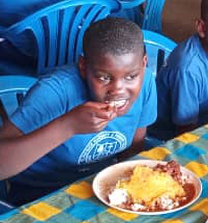 A Student eating matoke