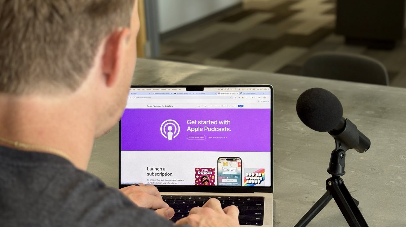Podcaster looking at Apple Podcasts screen