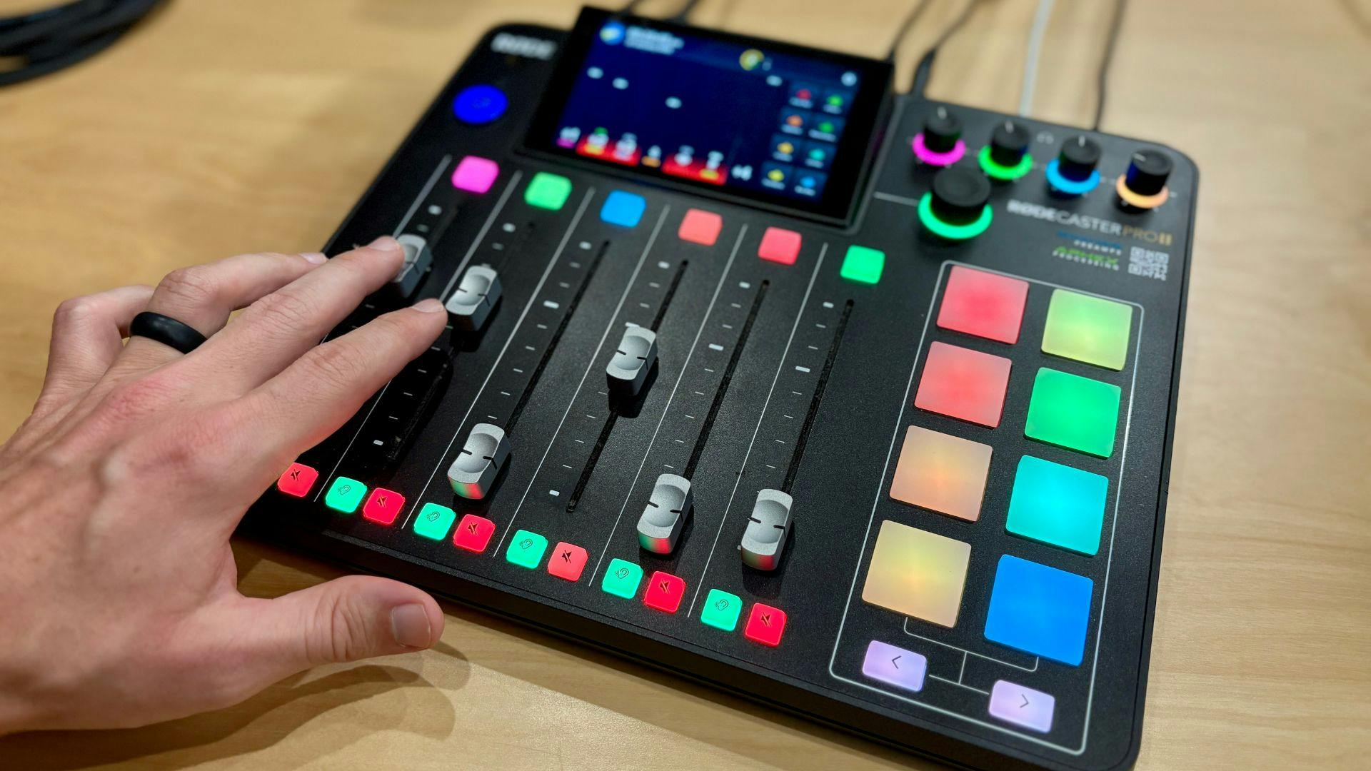 Podcaster adjusting audio levels on Rodecaster