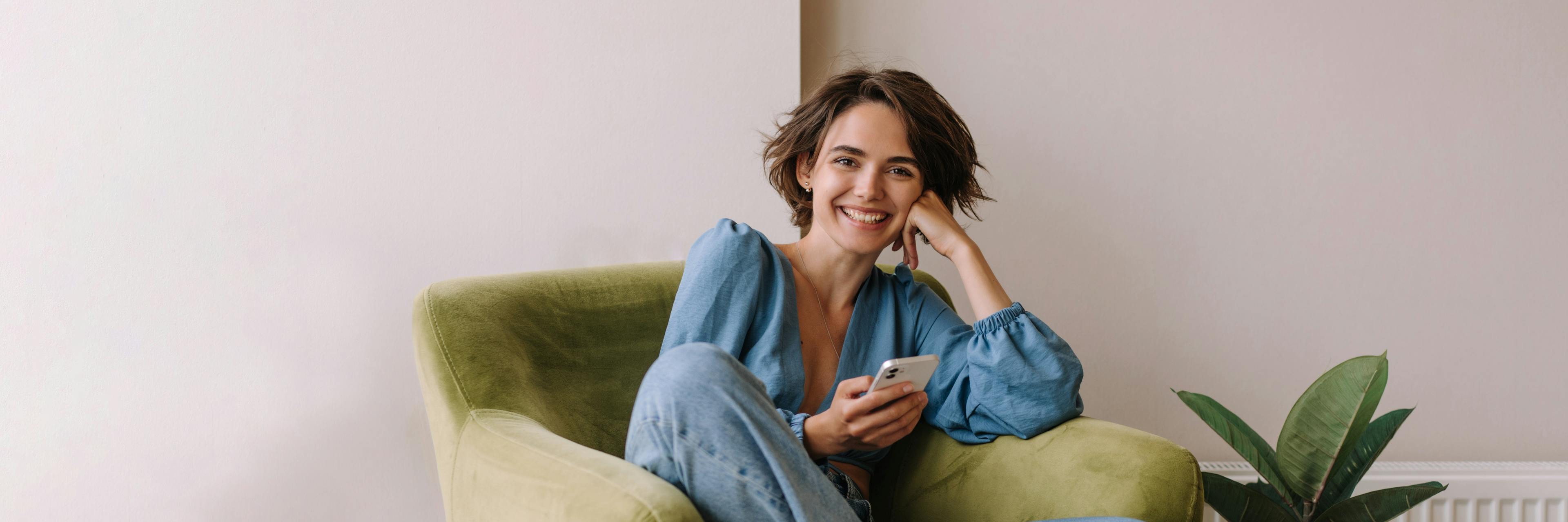 Woman smiling while relaxing in a chair.