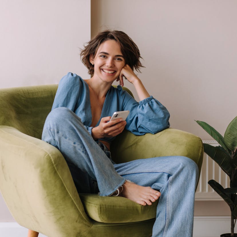 Woman smiling while relaxing in a chair.