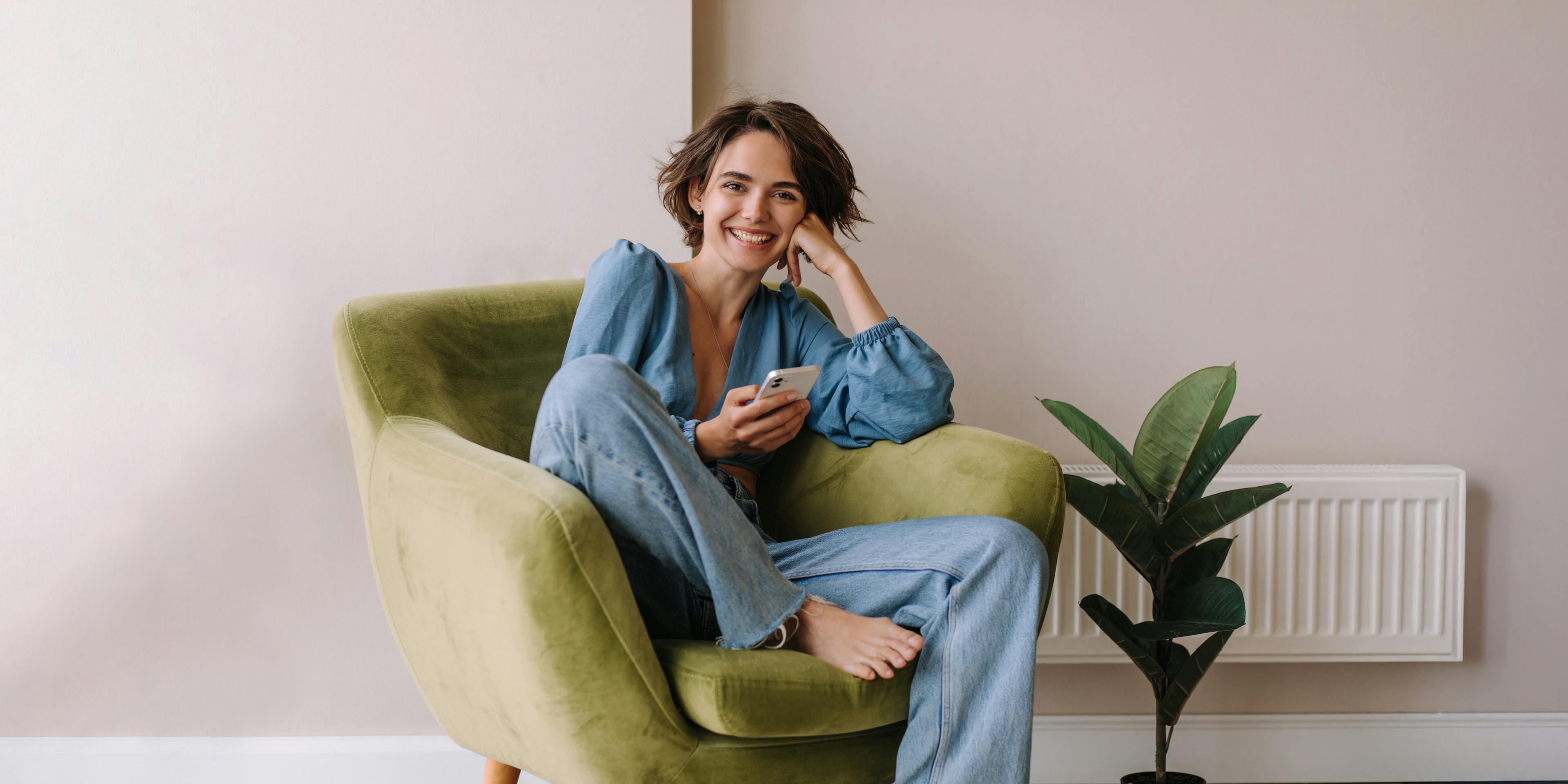 Woman smiling while relaxing in a chair.
