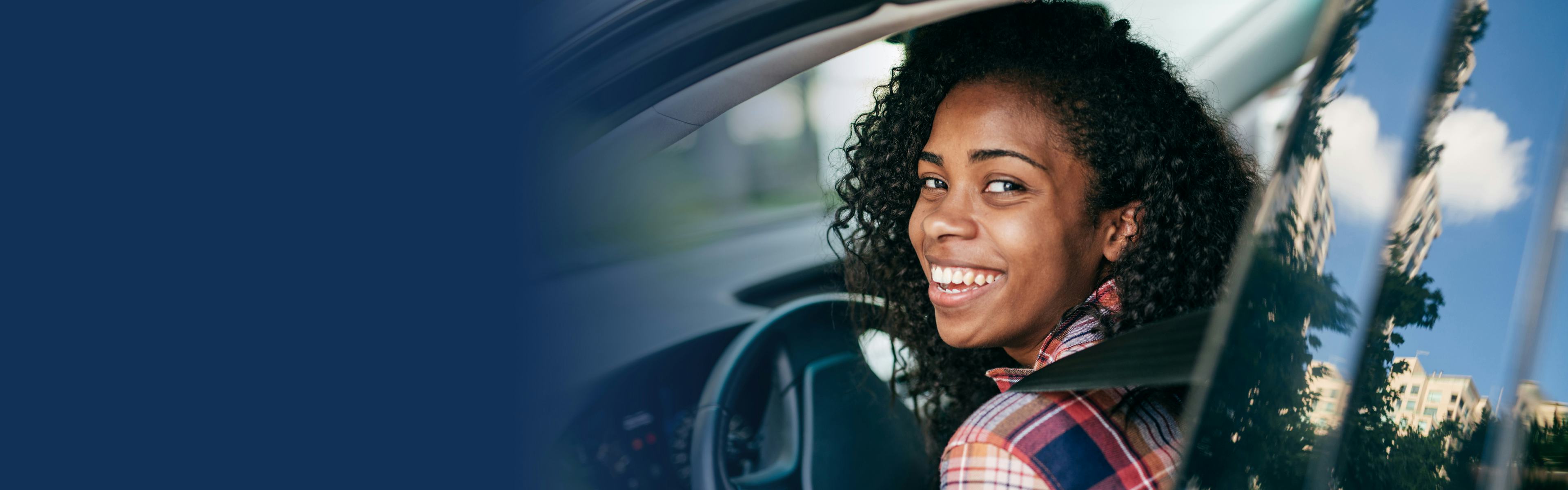 Woman in car smiling 