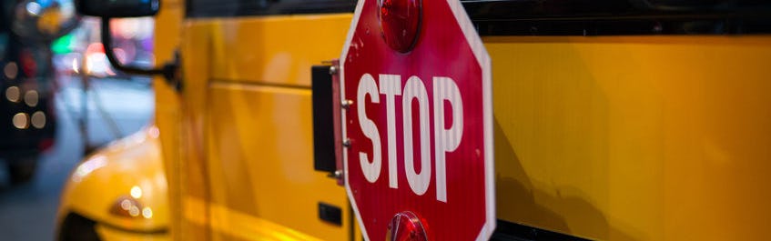 picture of the stop sign on the side of a school bus