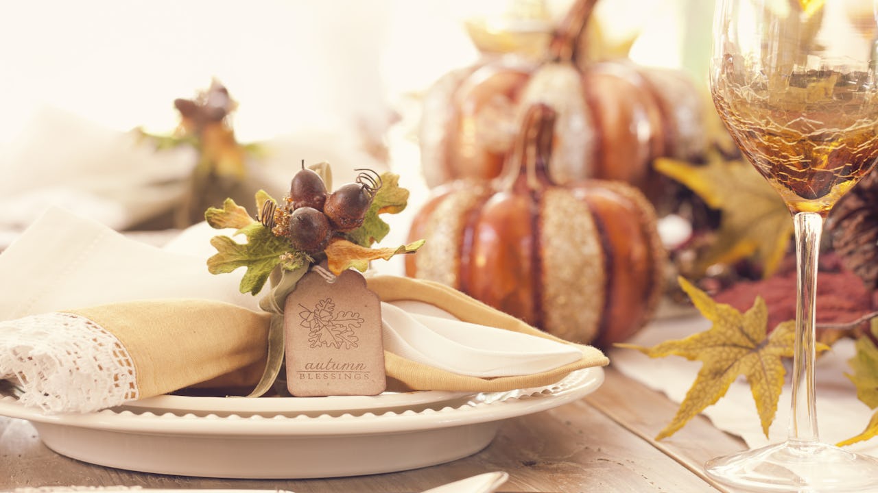 Thanksgiving holiday autumn place setting with place card and greeting.