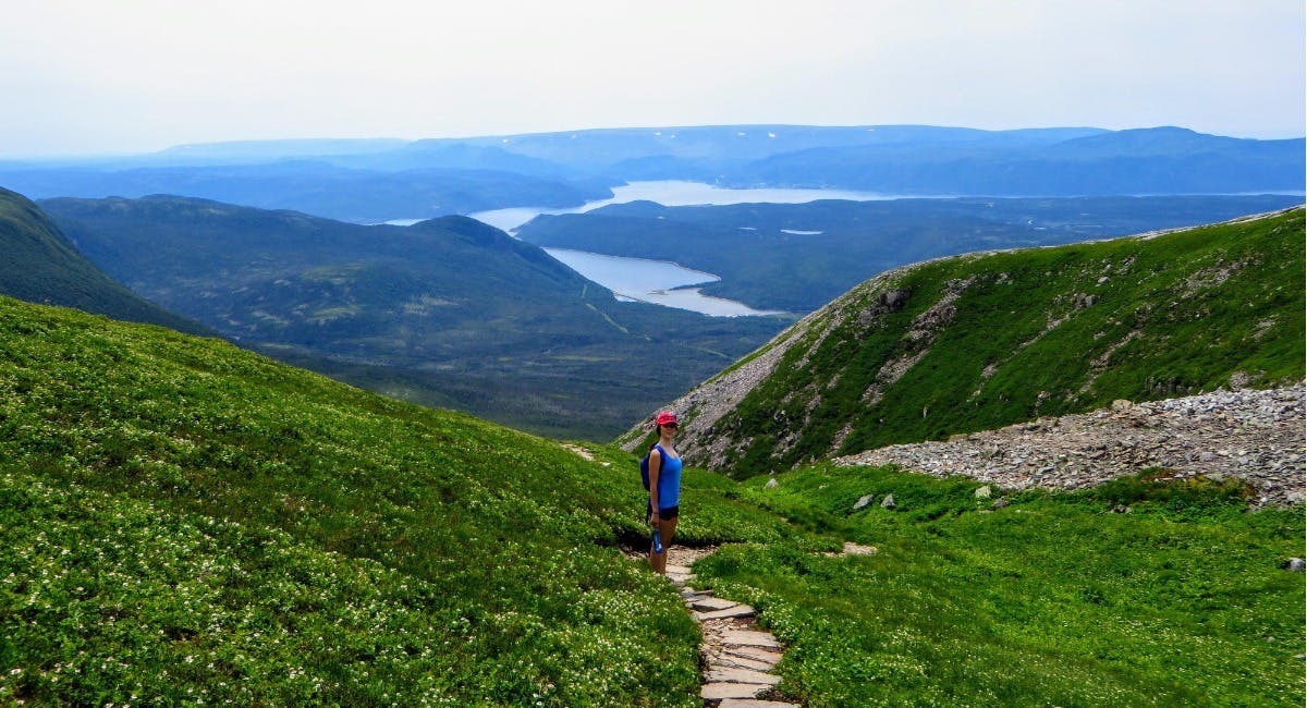 woman hiking on a mountain in Gros Morne National Park, Newfoundland and Labrador 