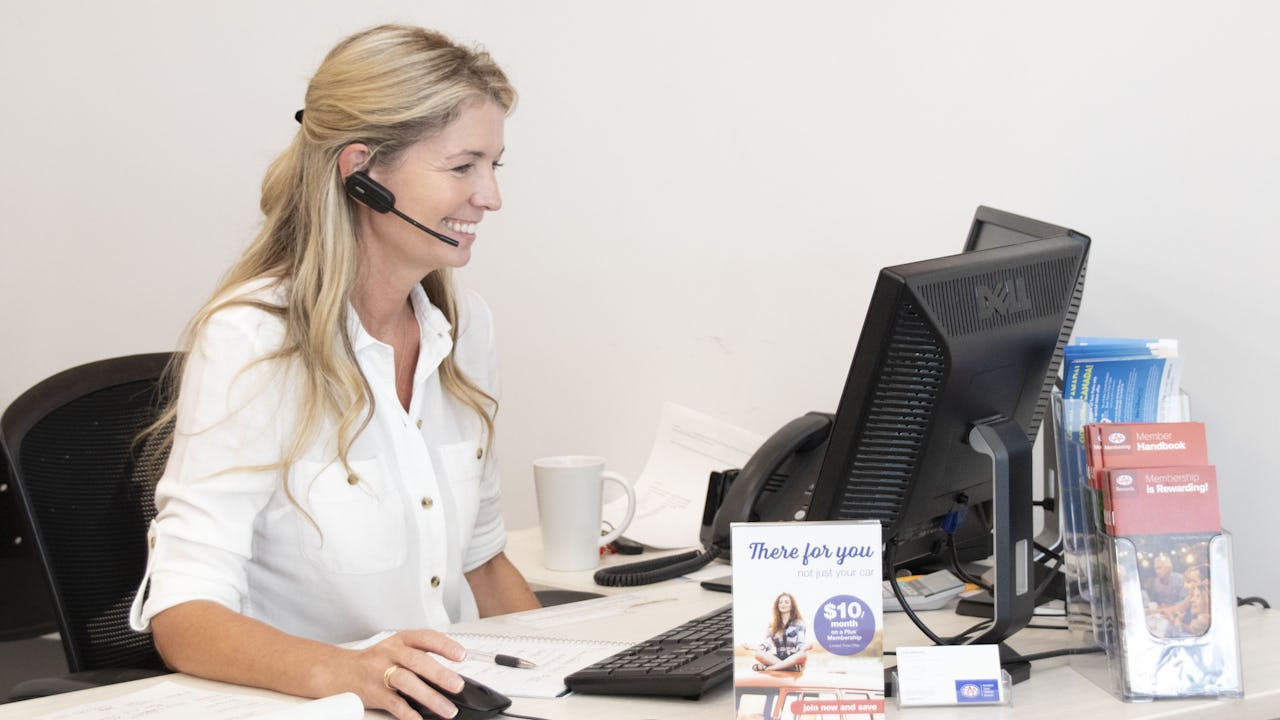 Girl on headset at CAA Travel store