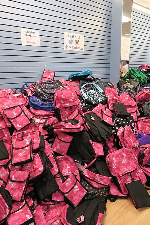 A picture of a pile of new backpacks