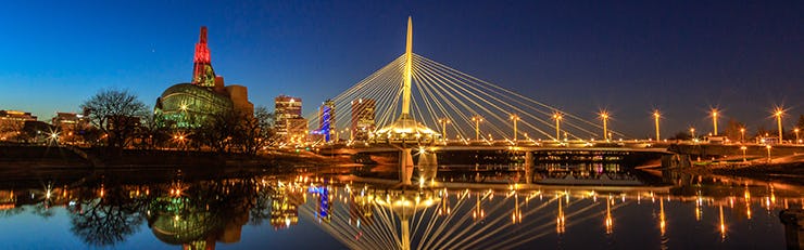 A picture of a bridge in Winnipeg, Manitoba lit up at night