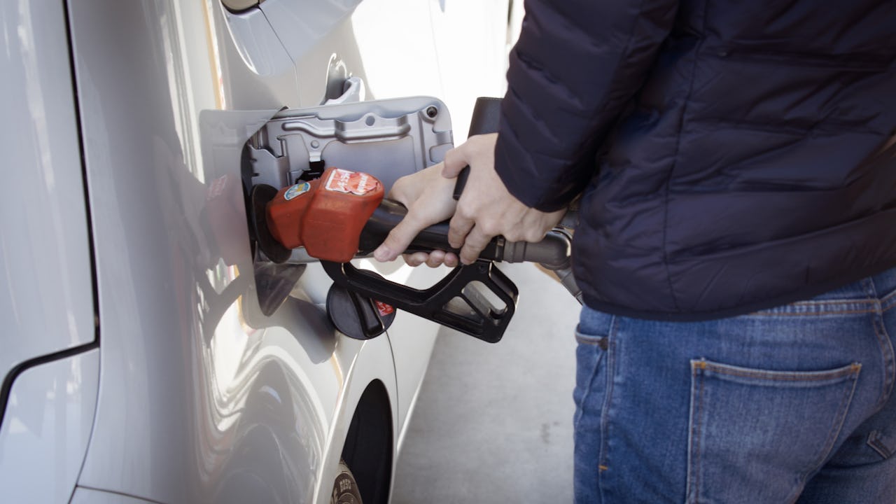 Person pumping fuel into their vehicle