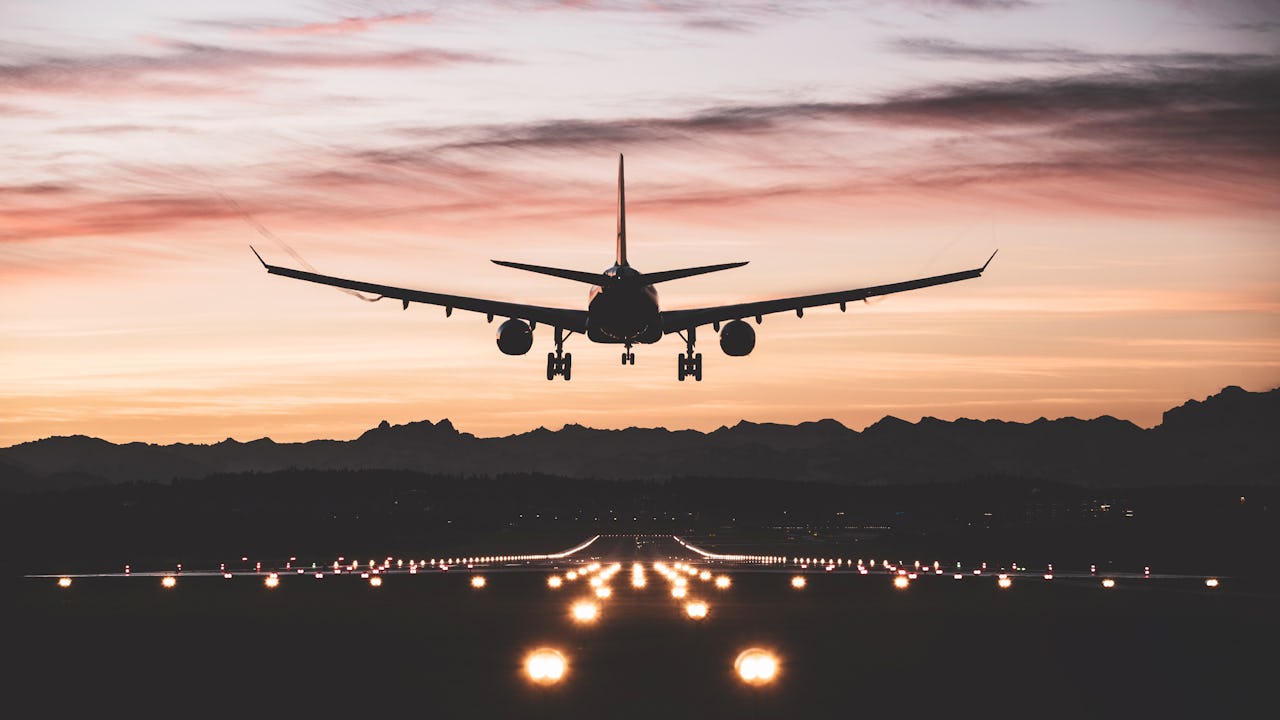 Airplane landing in sunset