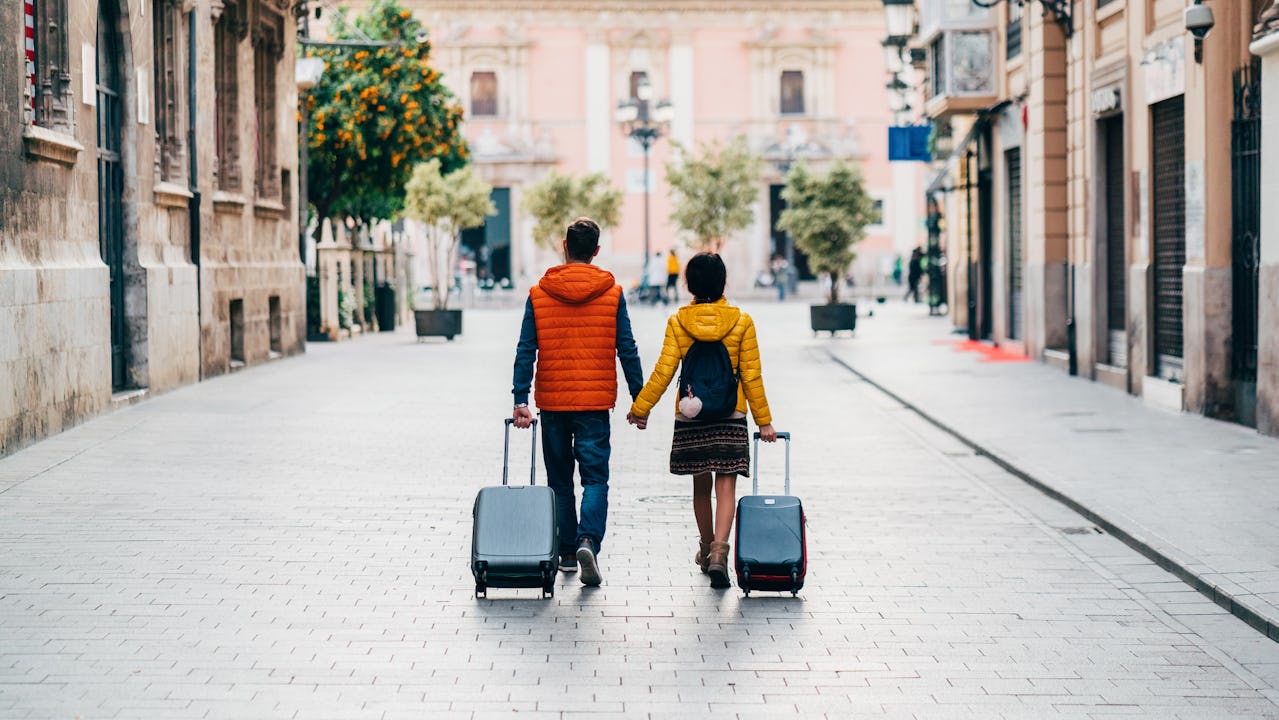 Young couple with suitcases just arriving in Valencia
